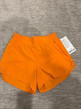 NWT Lululemon hottie hot HR short 4 inch in same lined. Size 8. Lit Orange